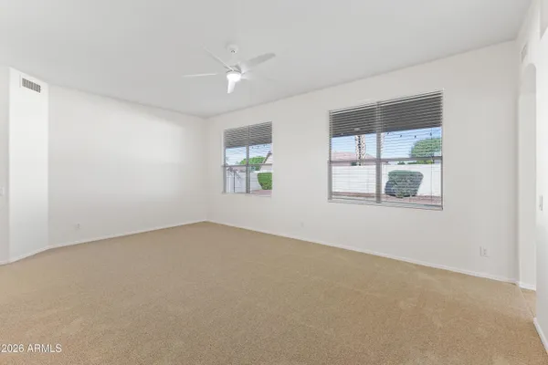 an empty room with windows and closet