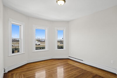 12 Redfield Street, Unit 3 Boston, MA 02122 - Photo 11 of 13 a view of an empty room with window and wooden floor