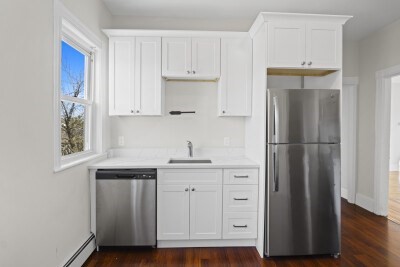 12 Redfield Street, Unit 3 Boston, MA 02122 - Photo 2 of 13 a kitchen with stainless steel appliances granite countertop a refrigerator and a sink