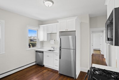 12 Redfield Street, Unit 3 Boston, MA 02122 - Photo 3 of 13 a kitchen with a refrigerator sink and cabinets