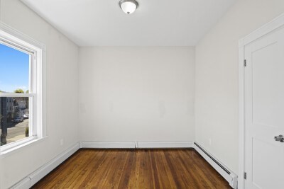 12 Redfield Street, Unit 3 Boston, MA 02122 - Photo 8 of 13 a view of a small space with wooden floor and a window