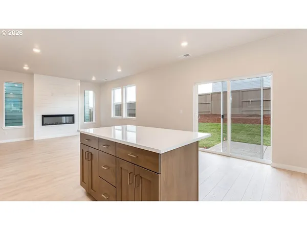a kitchen with kitchen island sink stove and refrigerator