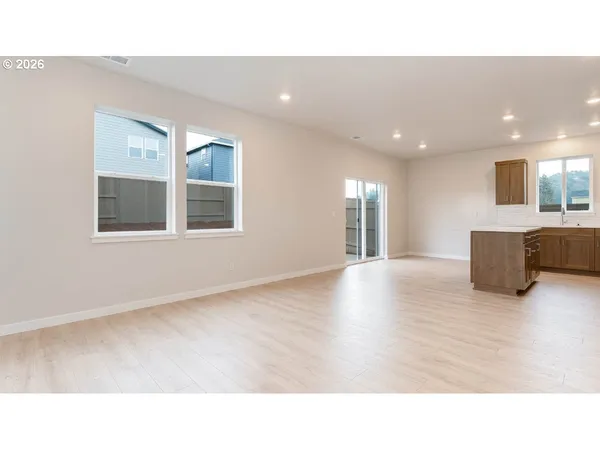 a open hall with wooden floor and windows