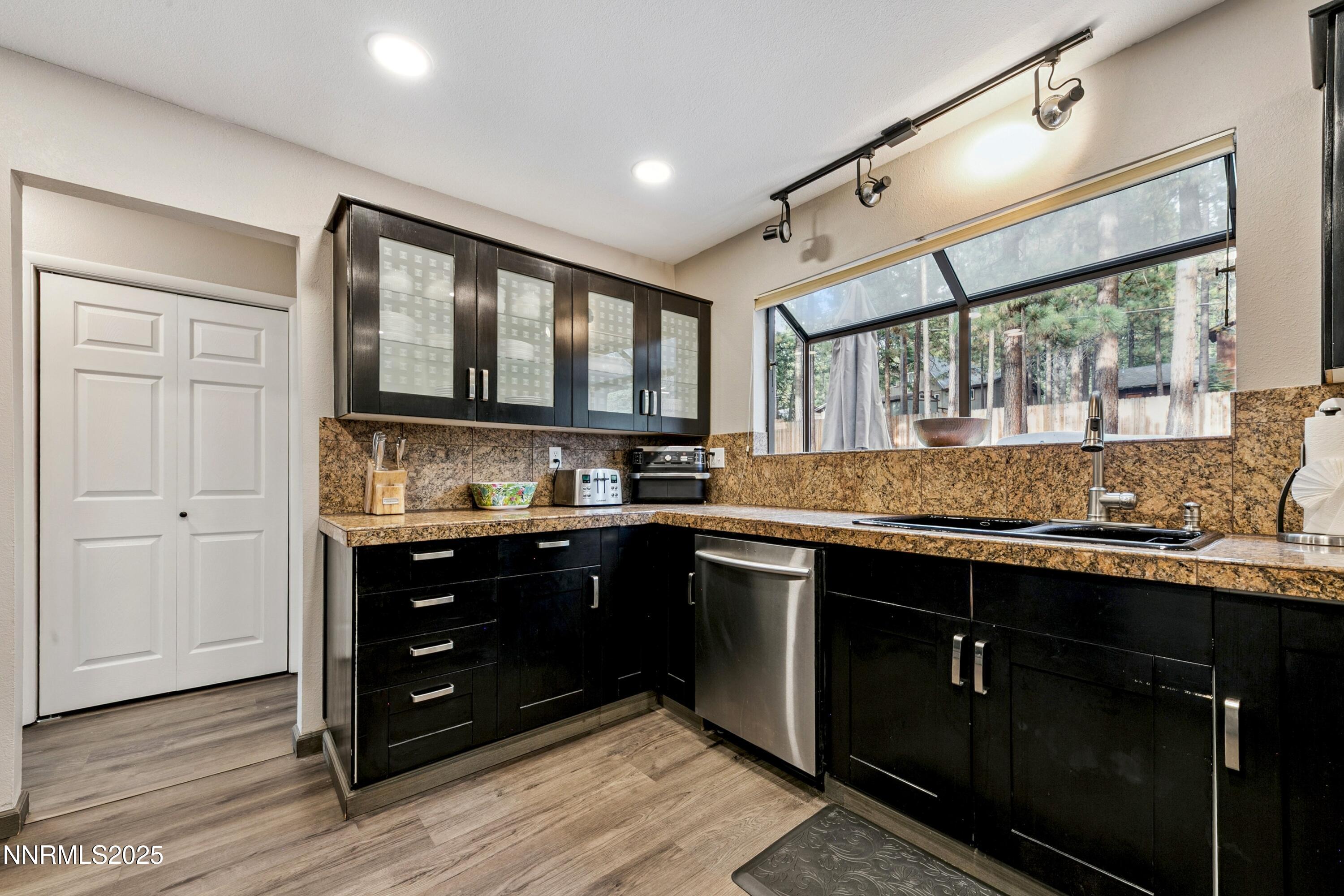 301 Chimney Rock Road Stateline, NV 89449 - Photo 11 of 38 a kitchen with stainless steel appliances granite countertop a stove and a sink