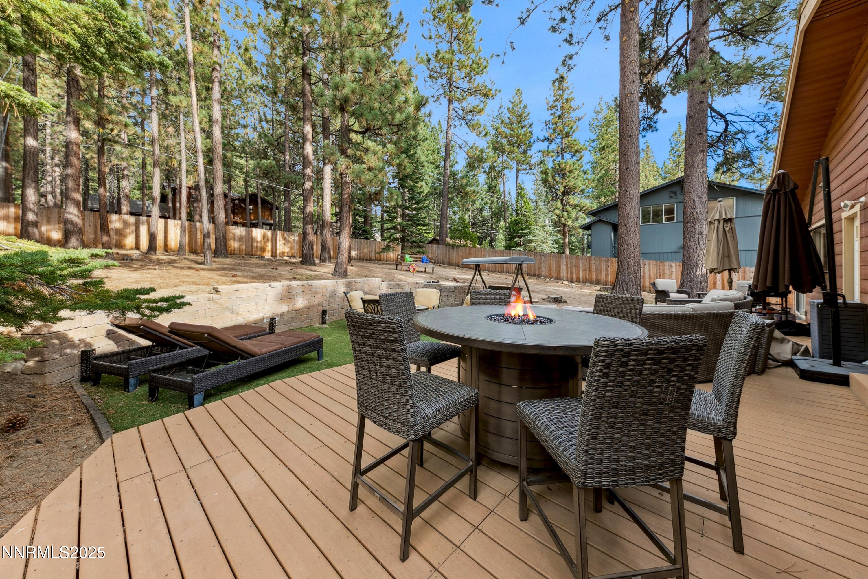 301 Chimney Rock Road Stateline, NV 89449 - Photo 23 of 38 a view of a patio with table and chairs and couches with wooden floor and fence