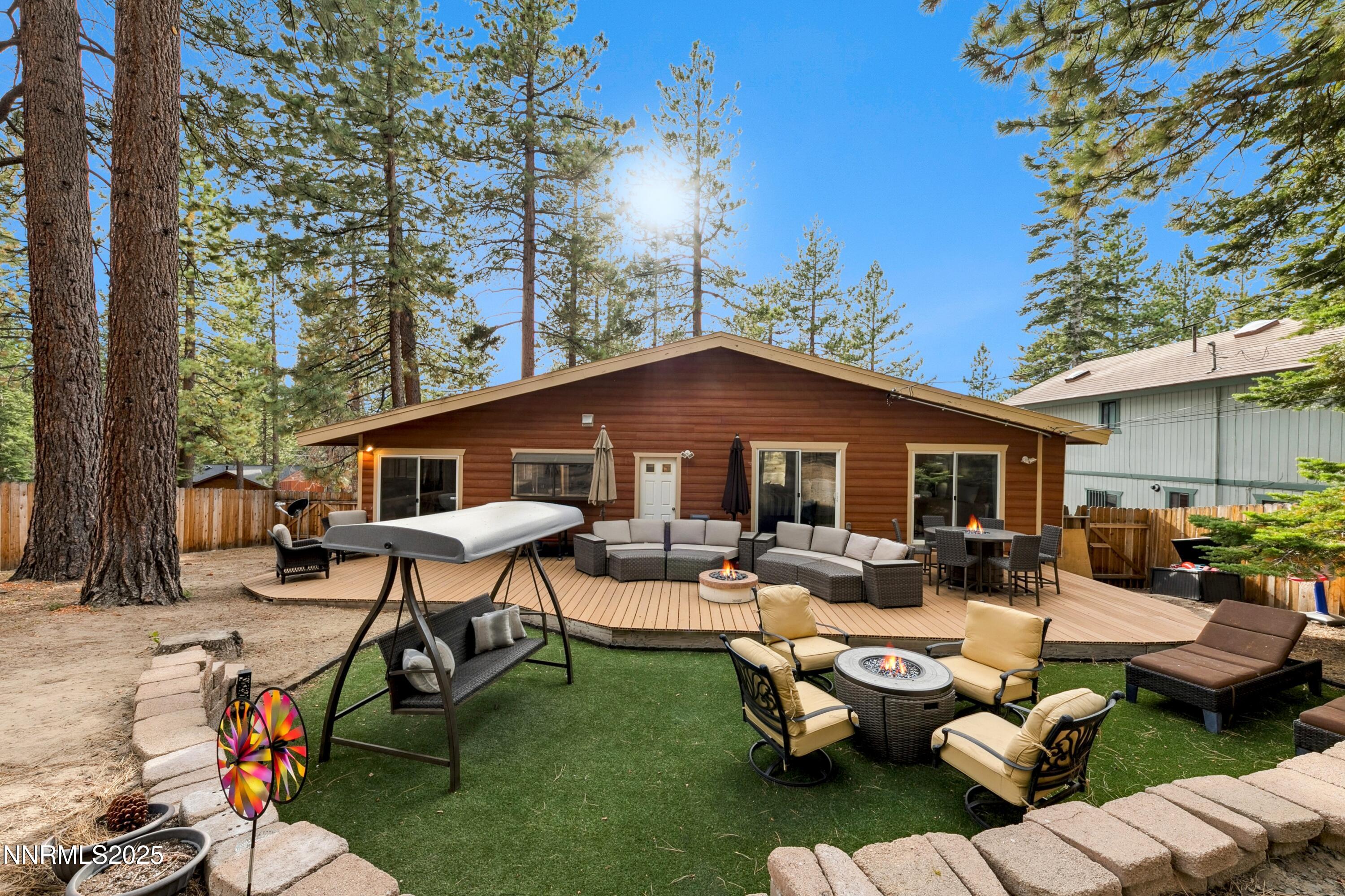 301 Chimney Rock Road Stateline, NV 89449 - Photo 25 of 38 a view of a patio with couches table and chairs under an umbrella