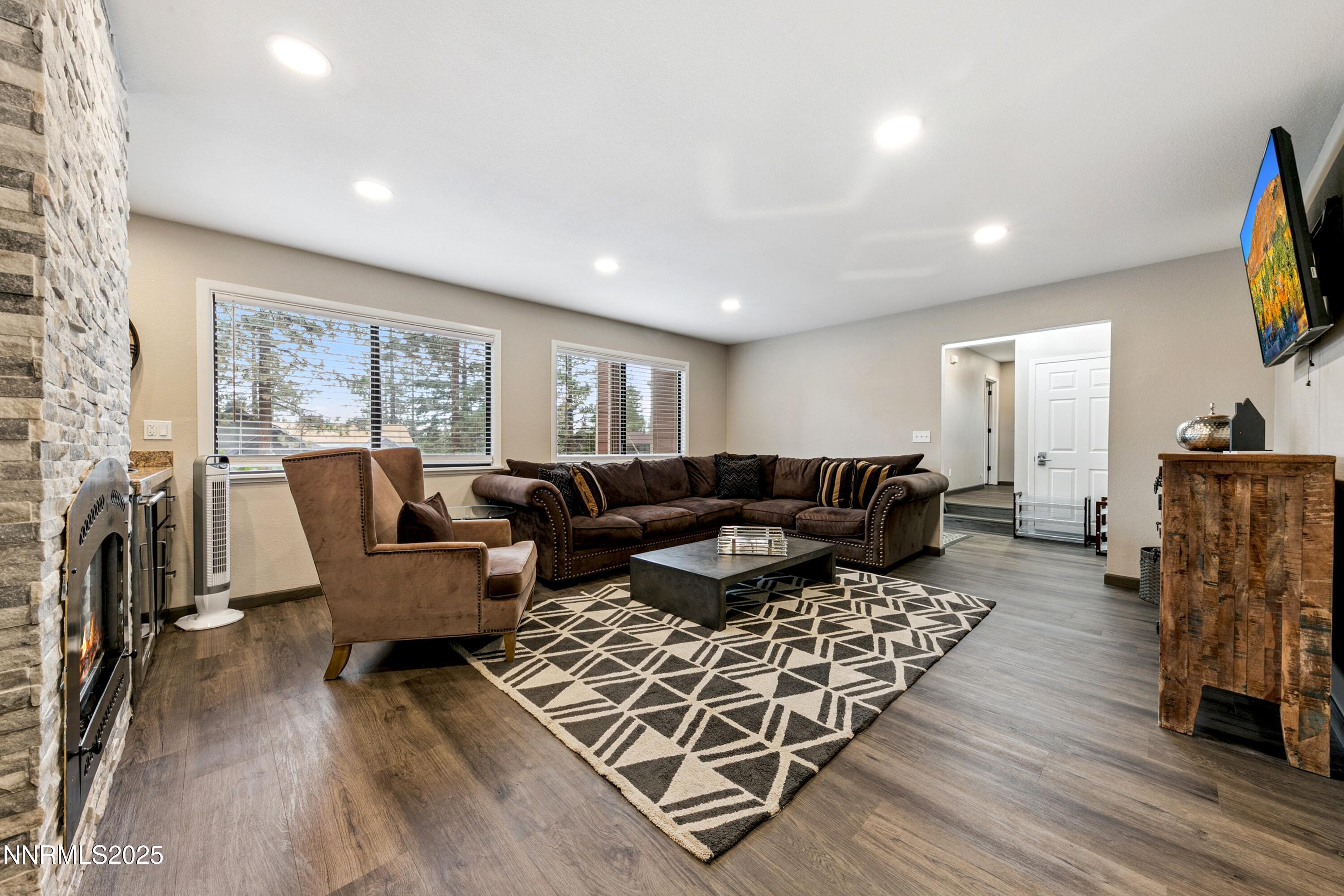 301 Chimney Rock Road Stateline, NV 89449 - Photo 3 of 38 a living room with furniture flat screen tv and a fireplace