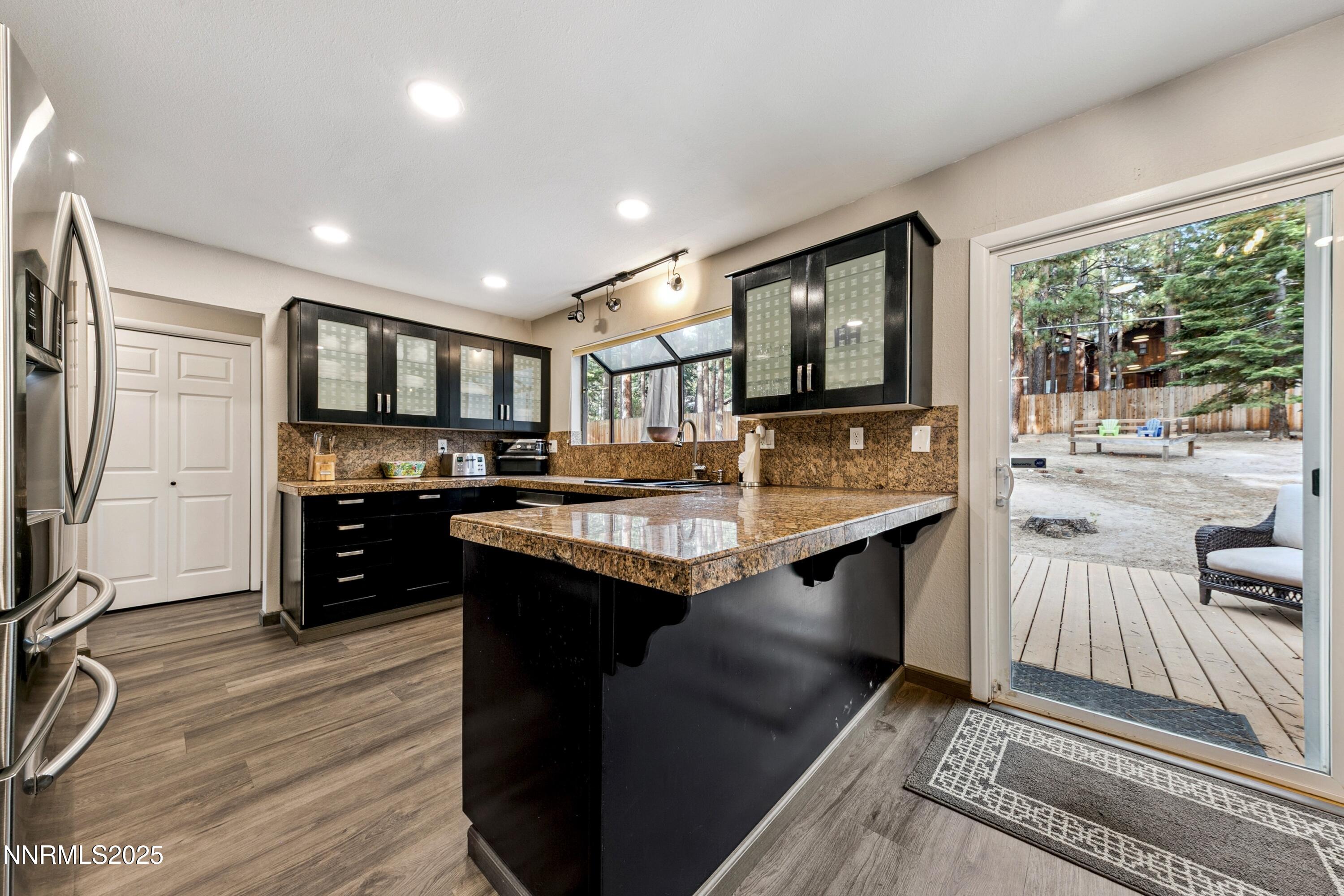 301 Chimney Rock Road Stateline, NV 89449 - Photo 8 of 38 a kitchen with stainless steel appliances granite countertop a sink stove and refrigerator