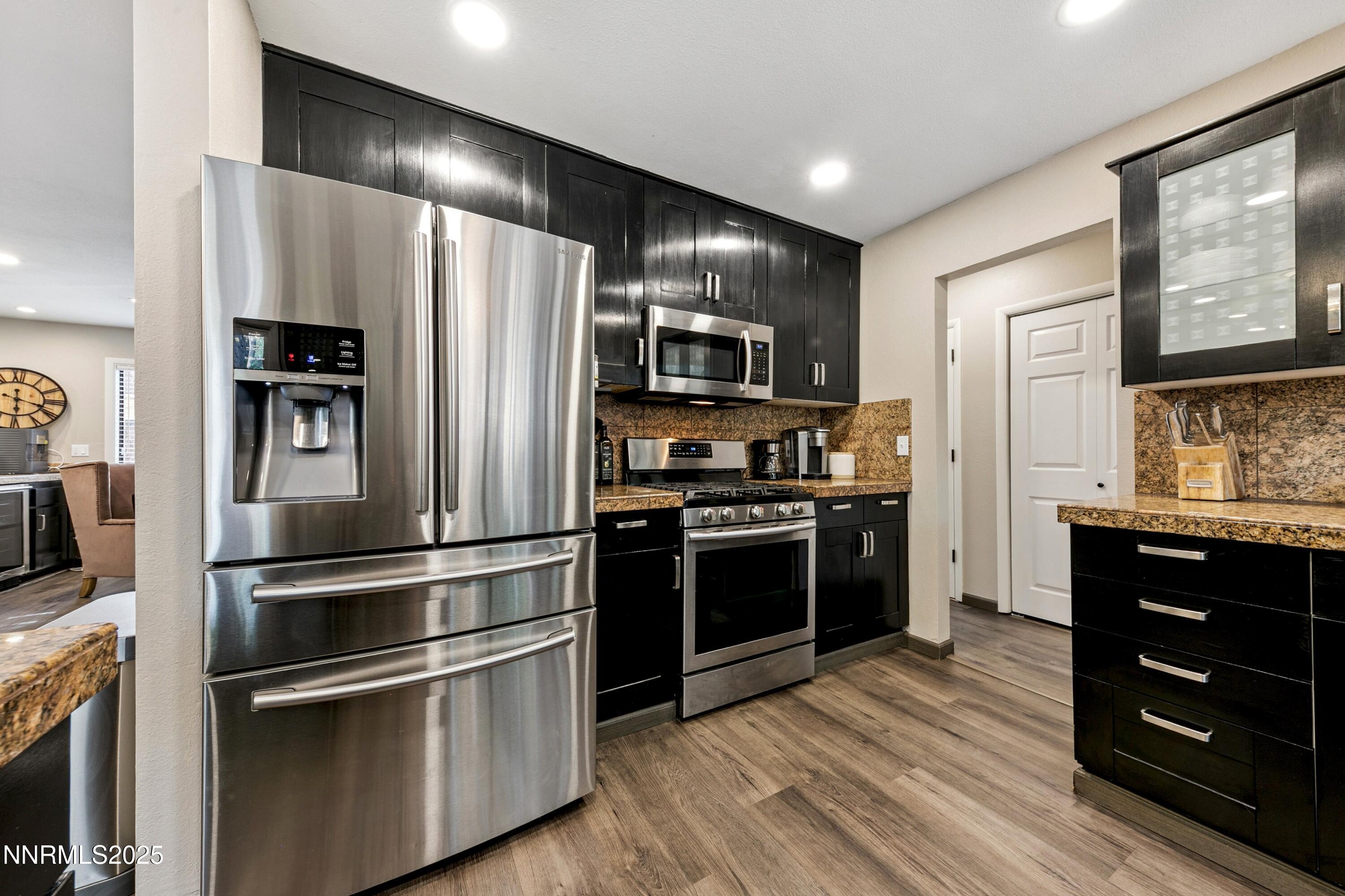 301 Chimney Rock Road Stateline, NV 89449 - Photo 10 of 38 a kitchen with stainless steel appliances and wooden floor