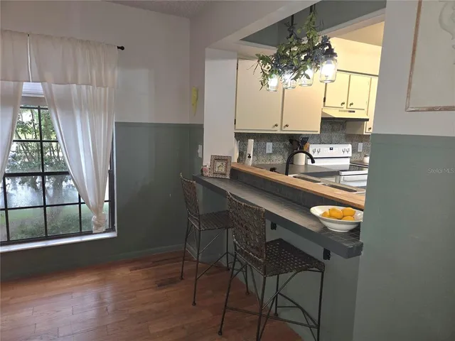 a kitchen with a sink a window and cabinets