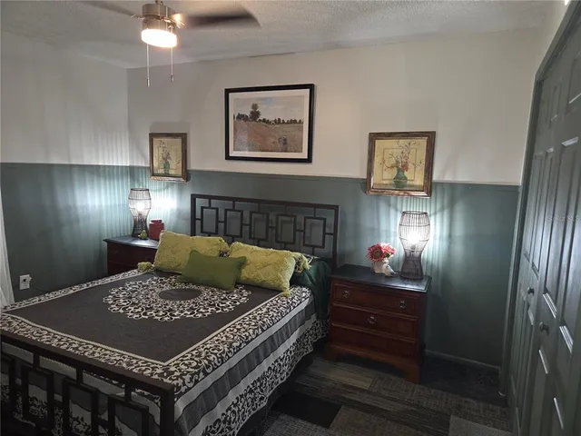 a bed sitting in a room next to a lamp