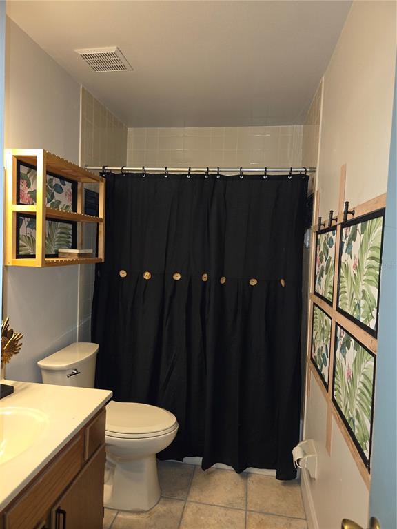1701 Southeast 24th Road, Unit 1901 Ocala, FL 34471 - Photo 5 of 13 a bathroom with a sink a toilet a mirror and shower