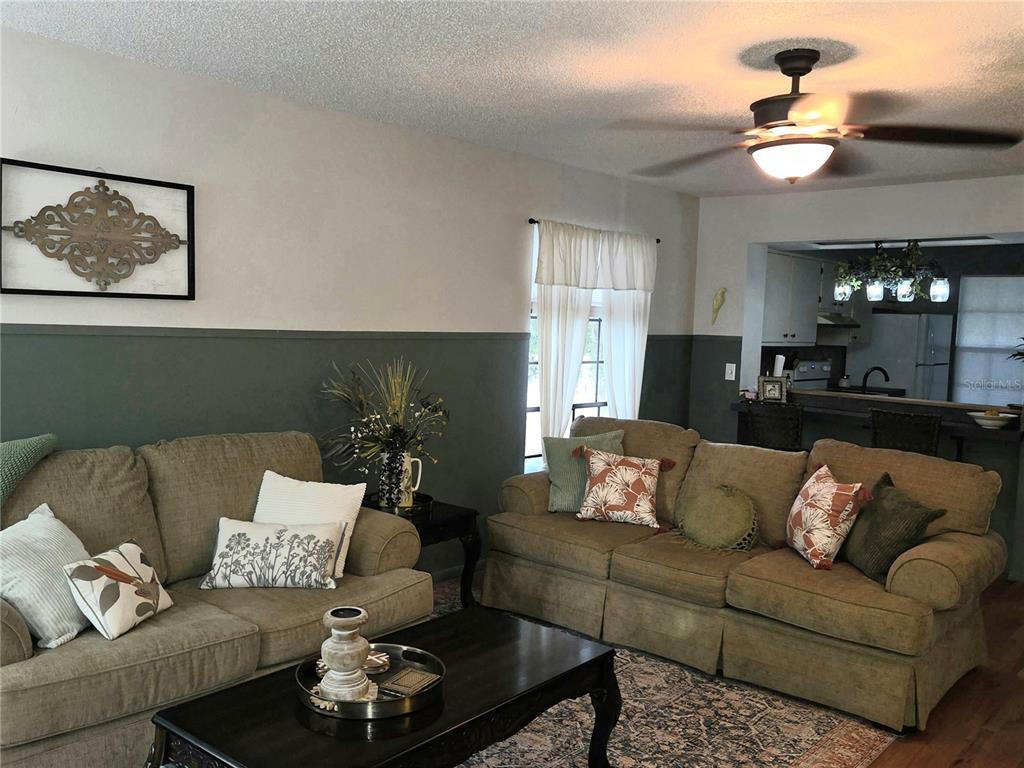 1701 Southeast 24th Road, Unit 1901 Ocala, FL 34471 - Photo 7 of 13 a living room with furniture and a chandelier