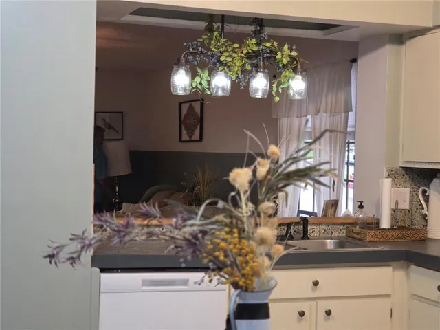 a bathroom with a sink a mirror and a potted plant