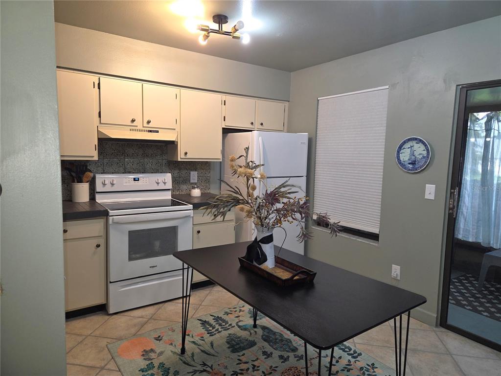 1701 Southeast 24th Road, Unit 1901 Ocala, FL 34471 - Photo 10 of 13 a kitchen with cabinets appliances and a counter top space