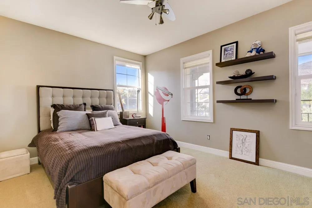 2936 Ranch Gate Road Chula Vista, CA 91914 - Photo 17 of 32 a bedroom with a bed and a chandelier