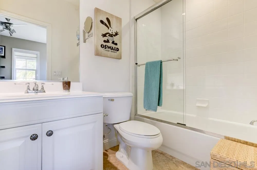 2936 Ranch Gate Road Chula Vista, CA 91914 - Photo 18 of 32 a bathroom with a toilet sink and mirror