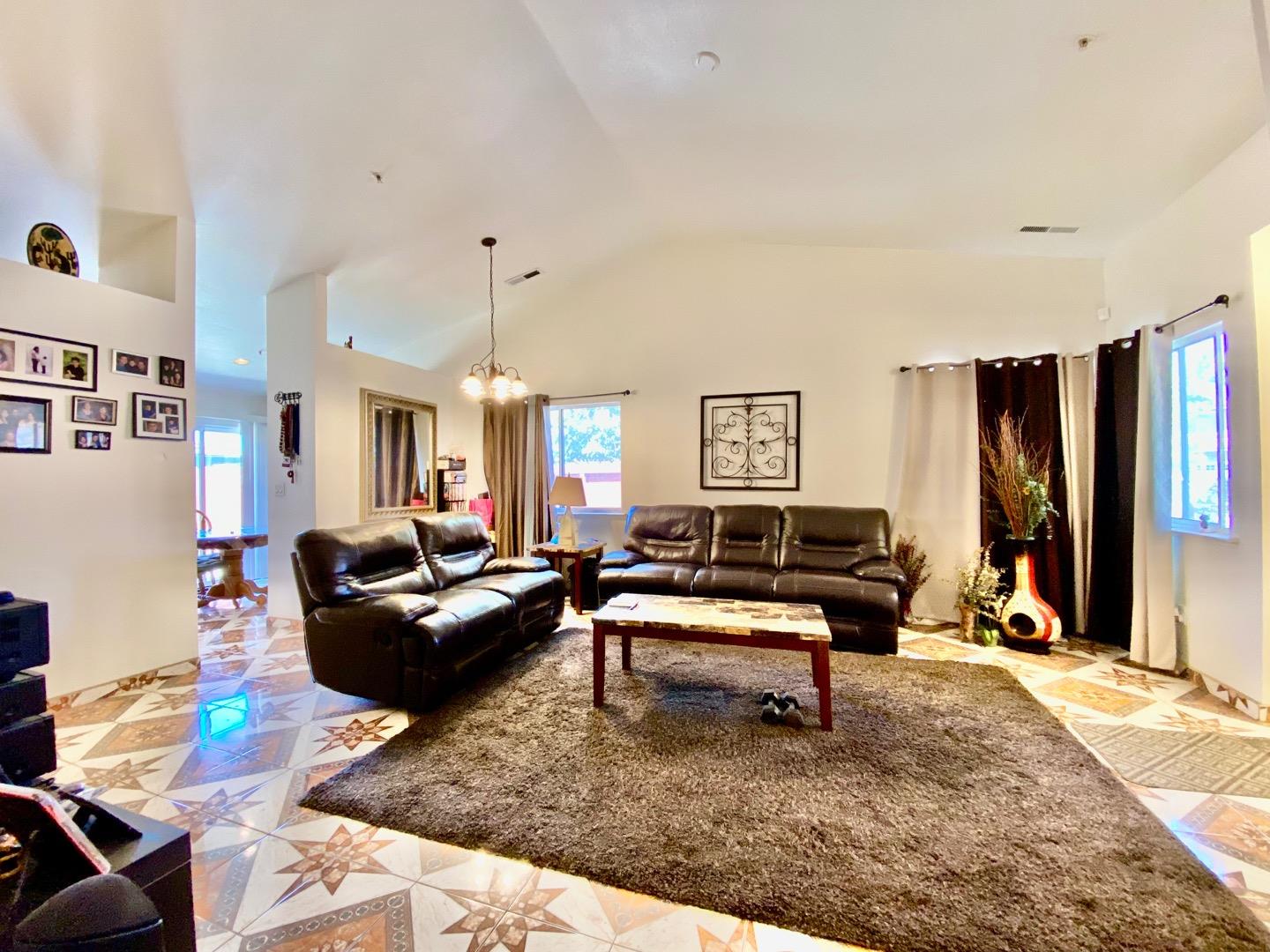 1015 Eagle Drive Salinas, CA 93905 - Photo 2 of 12 a living room with furniture a rug and a flat screen tv
