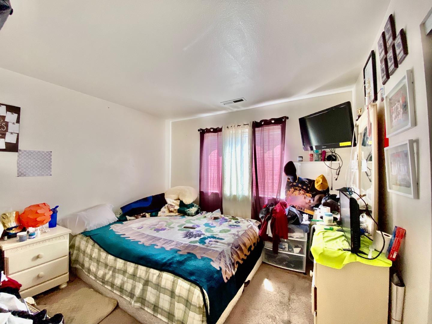 1015 Eagle Drive Salinas, CA 93905 - Photo 8 of 12 a bedroom with a bed and a flat screen tv