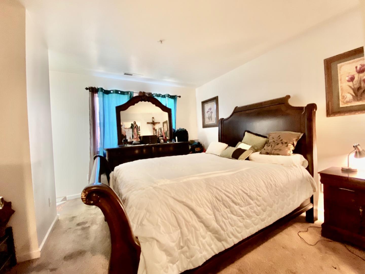 1015 Eagle Drive Salinas, CA 93905 - Photo 10 of 12 a bedroom with a bed and a painting on the wall