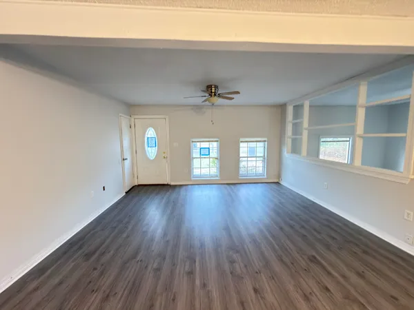 wooden floor in an empty room with a window