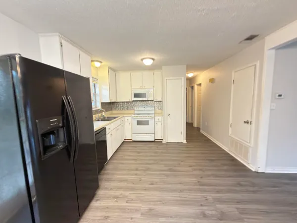 a kitchen with stainless steel appliances a refrigerator and a stove