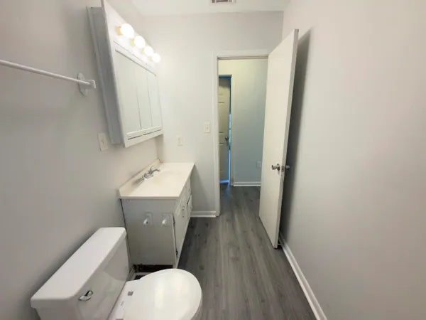 a white toilet sitting next to a bathroom sink