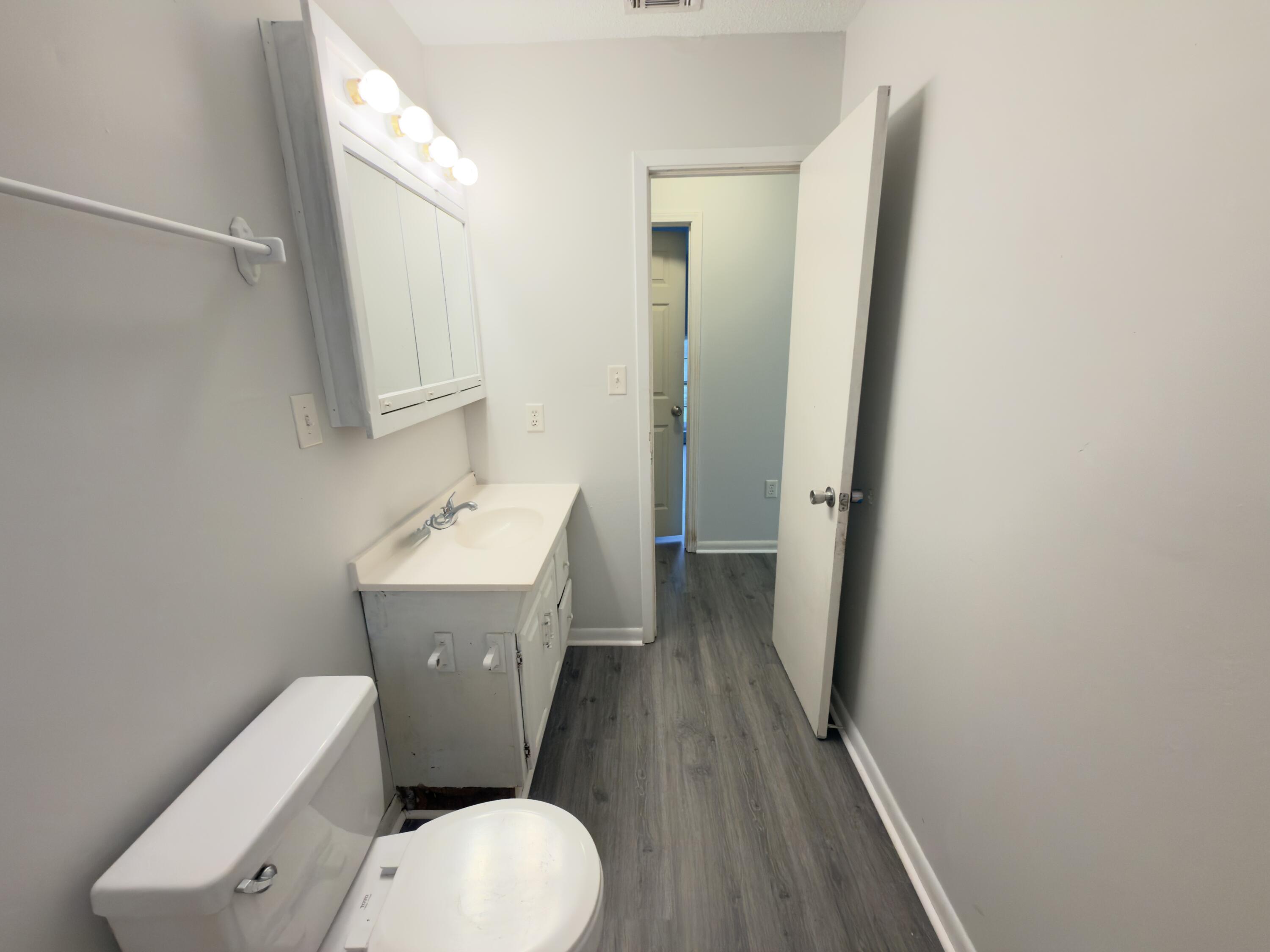 208 Forrest Parkway Crestview, FL 32539 - Photo 9 of 17 a white toilet sitting next to a bathroom sink