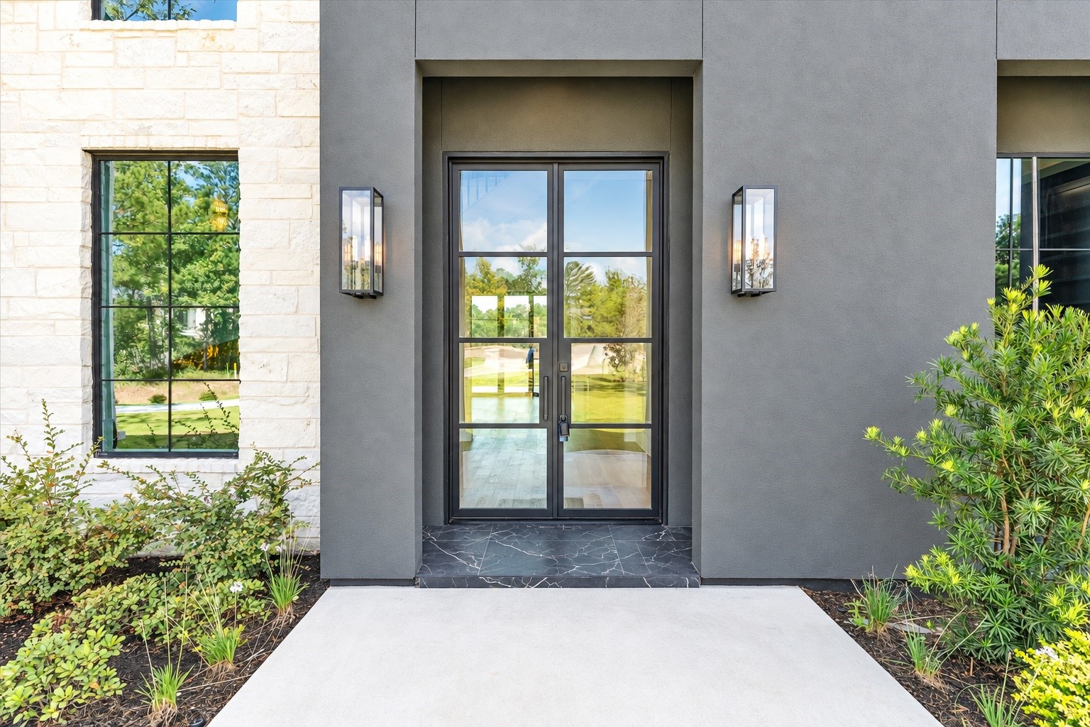 23701 Birch Grove Road Montgomery, TX 77316 - Photo 3 of 50 Striking stucco facade complemented by a grand 10-foot metal door exudes modern elegance.