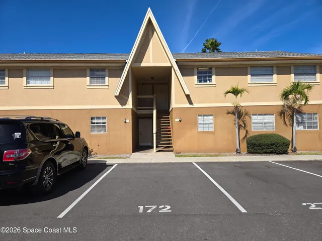 a view of a car parked front of a house
