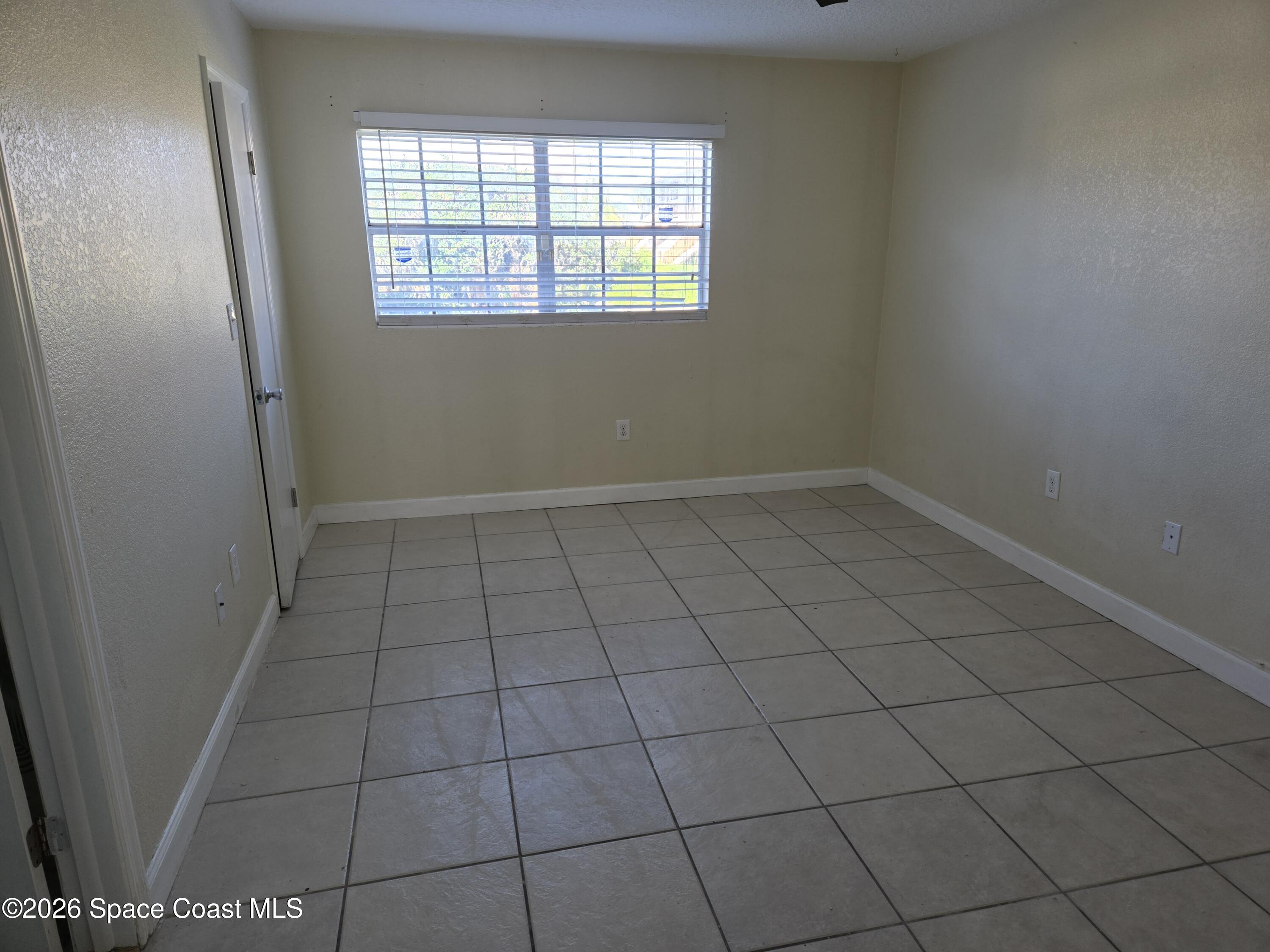174 Ulster Lane Melbourne, FL 32935 - Photo 13 of 25 an empty room with a window