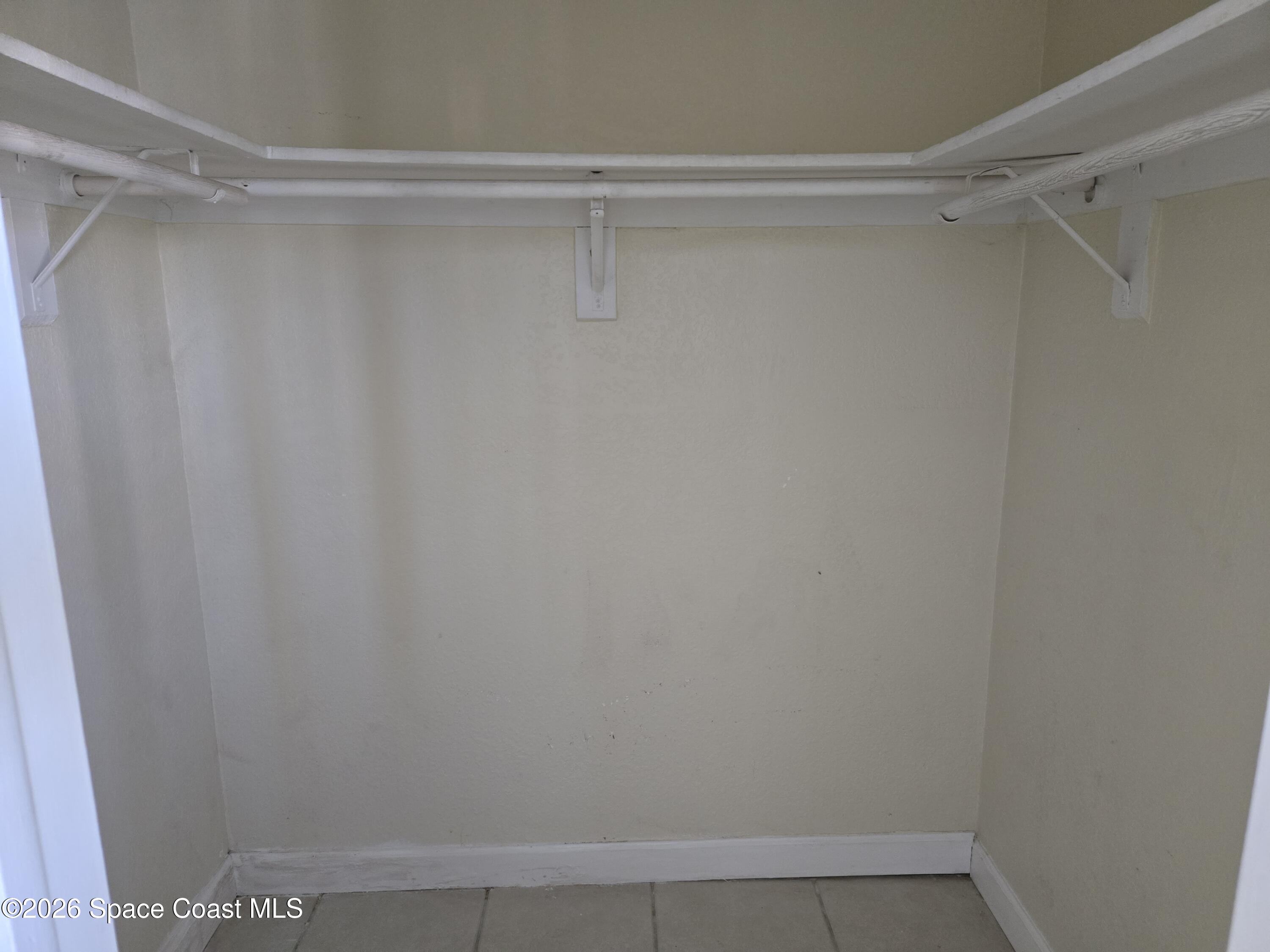 174 Ulster Lane Melbourne, FL 32935 - Photo 14 of 25 a view of a room with shelf on the wall