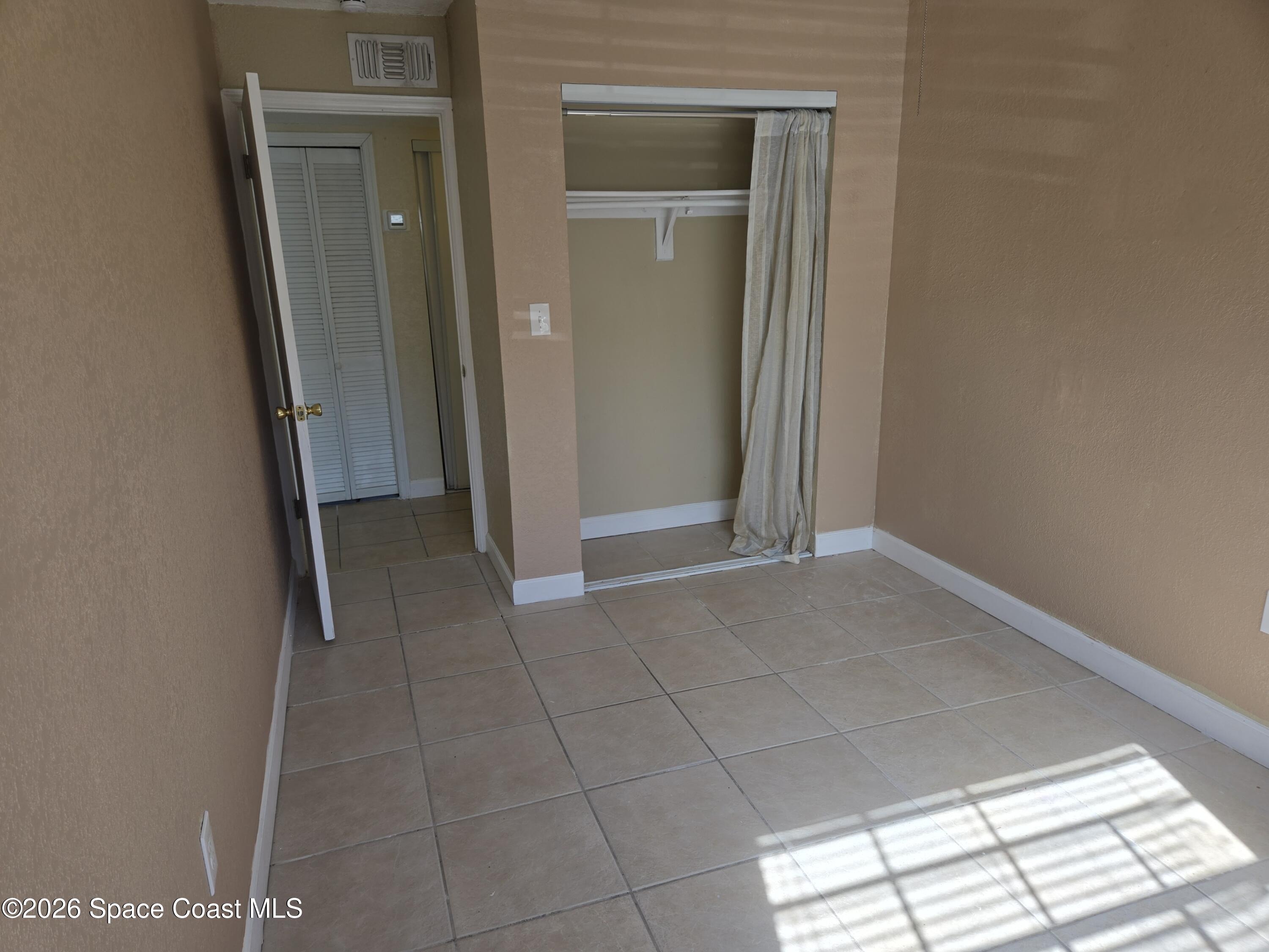 174 Ulster Lane Melbourne, FL 32935 - Photo 17 of 25 a view of livingroom with an empty space and a window