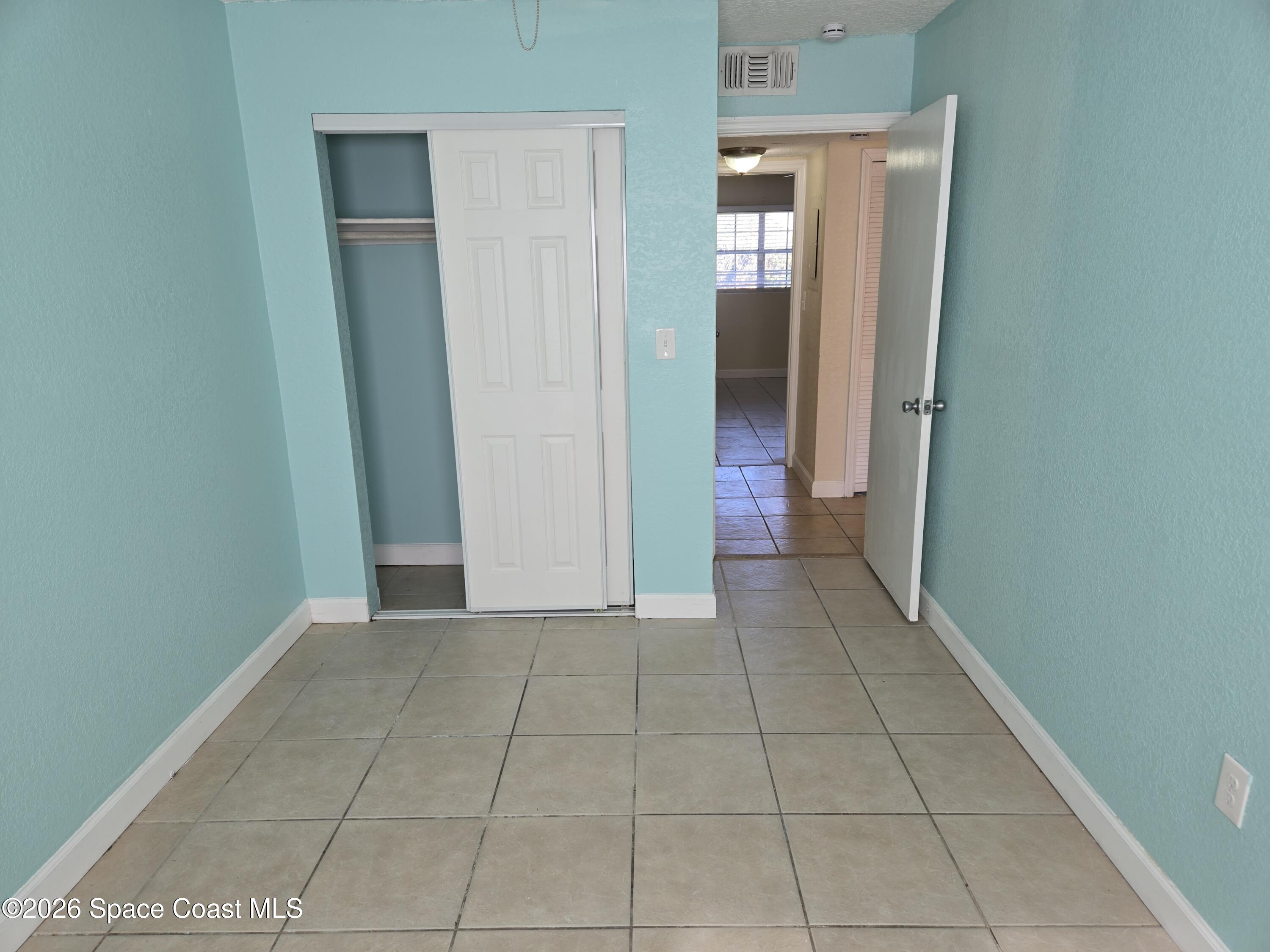 174 Ulster Lane Melbourne, FL 32935 - Photo 21 of 25 a view of an empty room with closet and a window