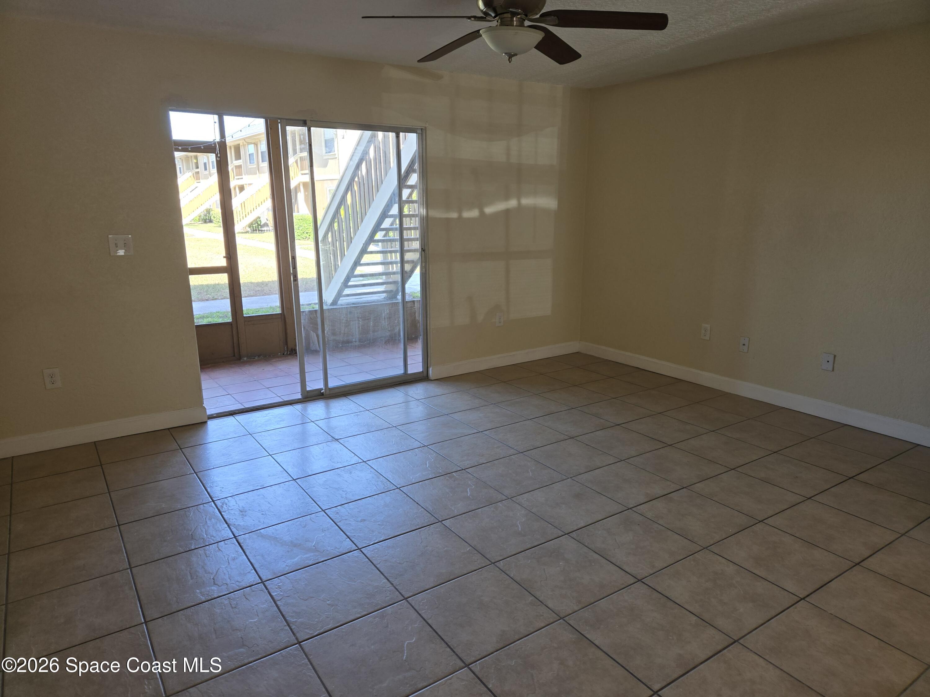 174 Ulster Lane Melbourne, FL 32935 - Photo 4 of 25 an empty room with a empty space and windows