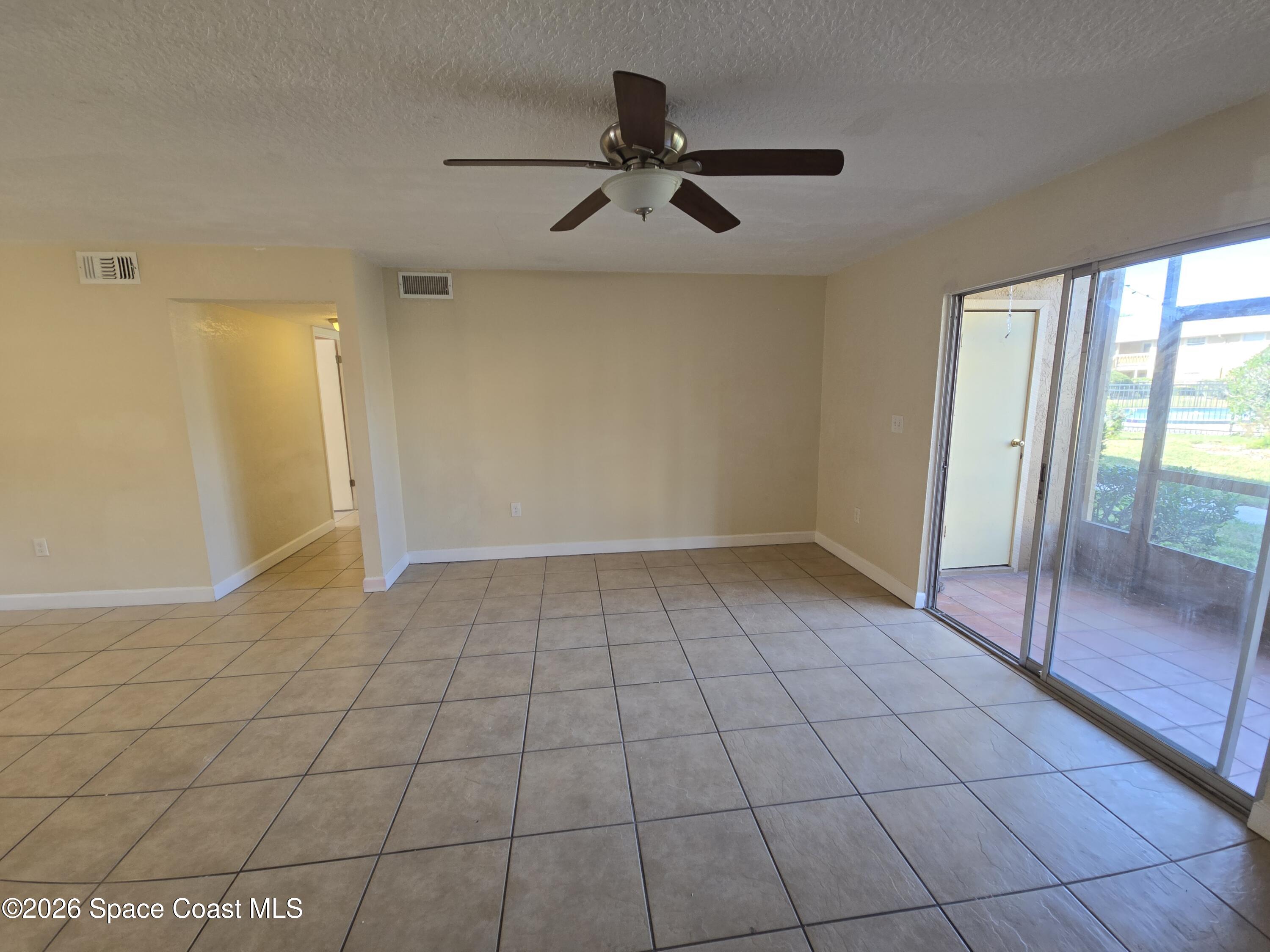 174 Ulster Lane Melbourne, FL 32935 - Photo 6 of 25 a view of an empty room and window