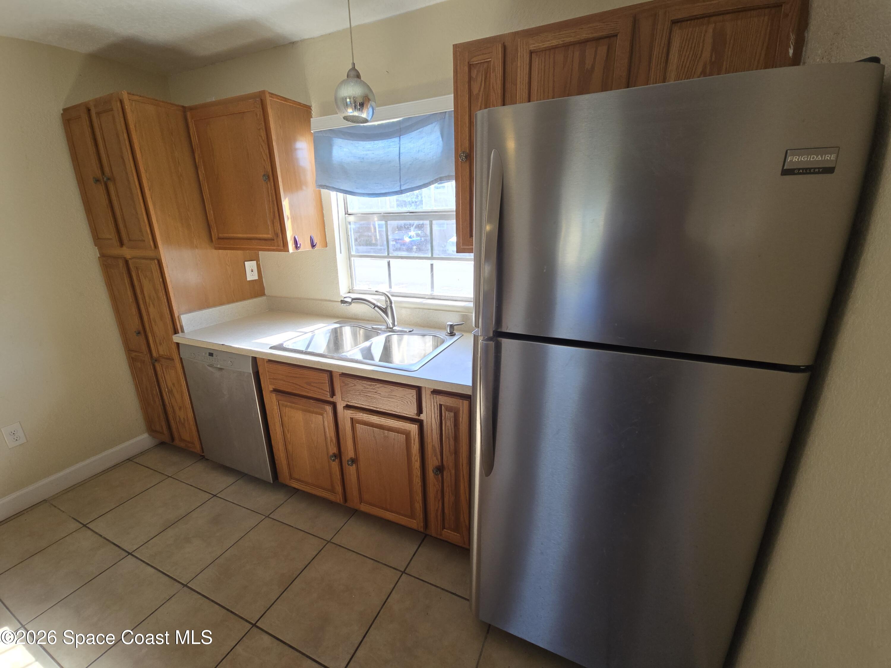 174 Ulster Lane Melbourne, FL 32935 - Photo 8 of 25 a kitchen with stainless steel appliances granite countertop a refrigerator and a sink