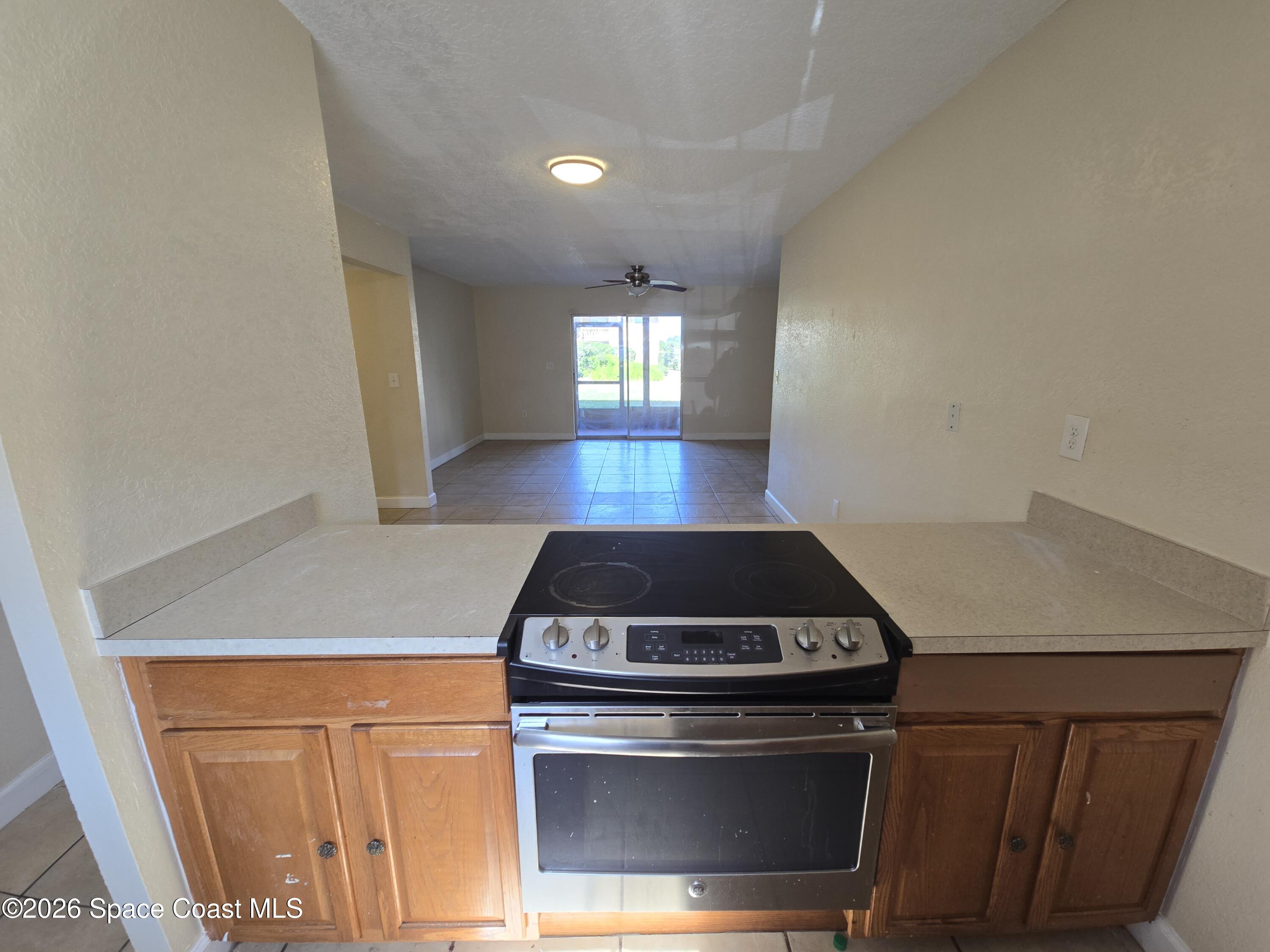 174 Ulster Lane Melbourne, FL 32935 - Photo 9 of 25 a stove top oven sitting inside of a kitchen