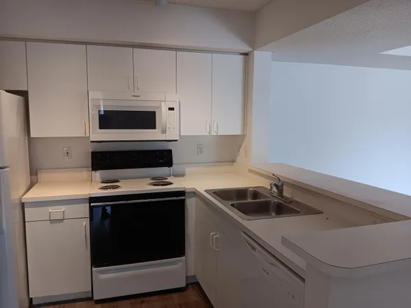 a kitchen with a sink and cabinets