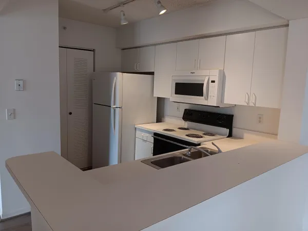 a kitchen with stainless steel appliances a refrigerator stove and microwave