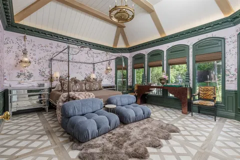 a living room with furniture and a floor to ceiling window