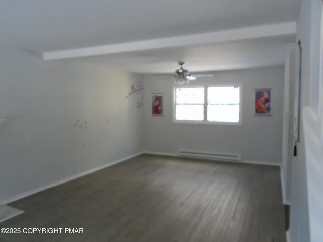 a view of staircase with railing and white walls