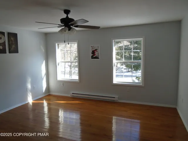 a view of an entryway with wooden floor and windows