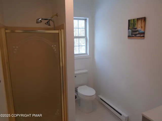 an empty room with a window and wooden floor