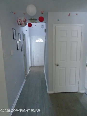 an empty room with a windows and ceiling fan