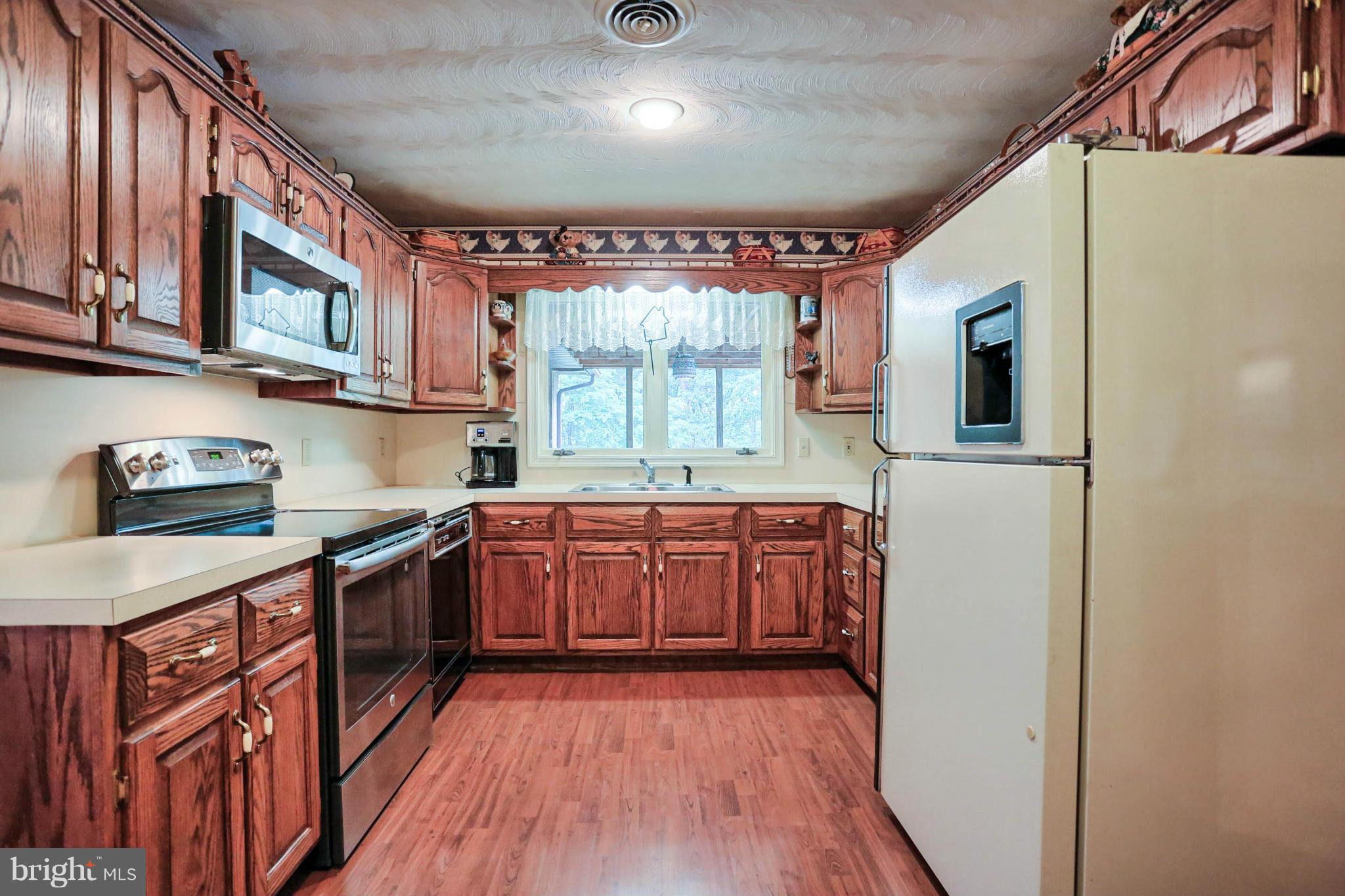 10852 Garrison Hollow Road Clear Spring, MD 21722 - Photo 11 of 30 a kitchen with stainless steel appliances granite countertop a stove a sink and a refrigerator