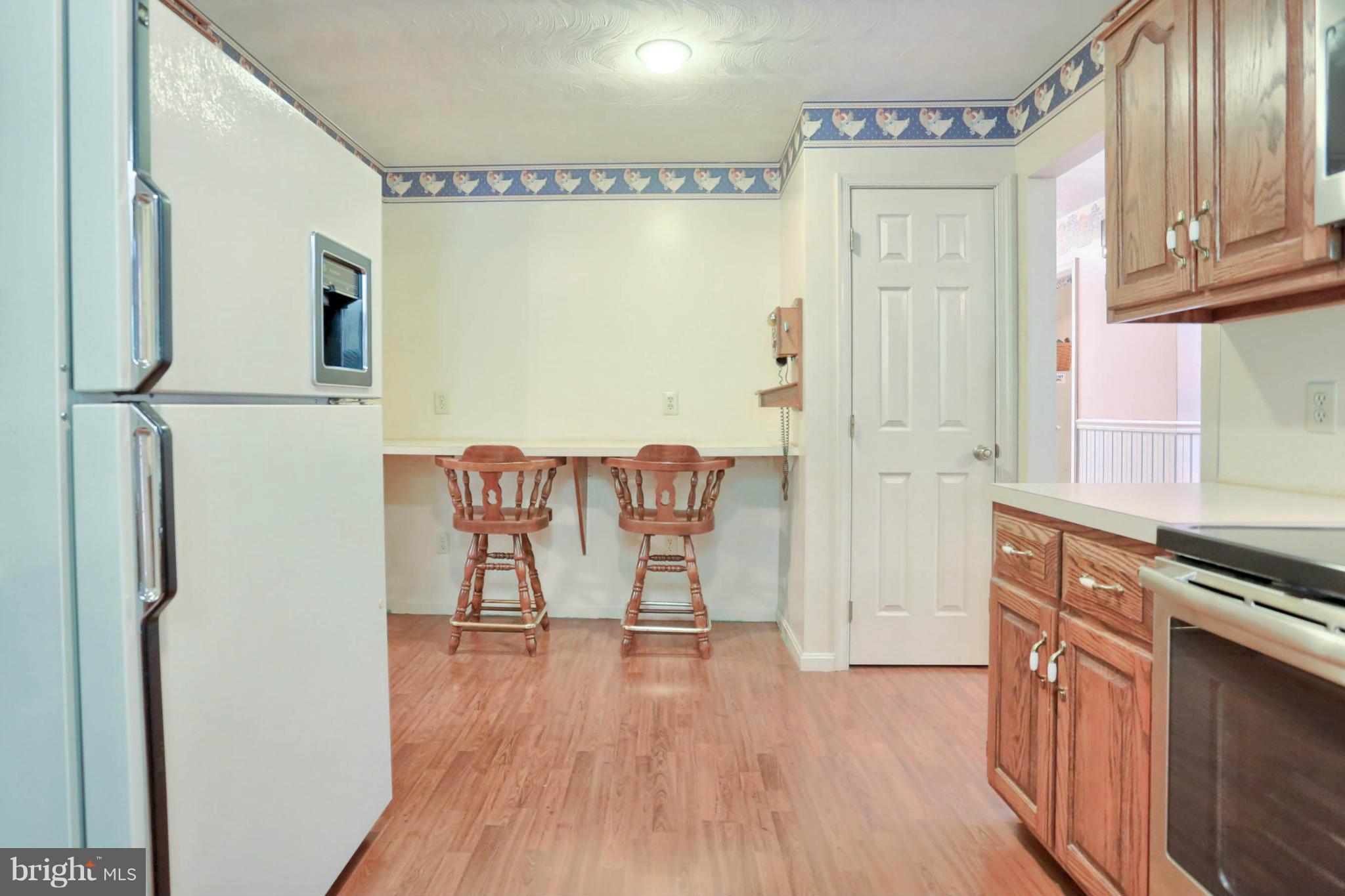 10852 Garrison Hollow Road Clear Spring, MD 21722 - Photo 13 of 30 a view of a kitchen with wooden floor and electronic appliances