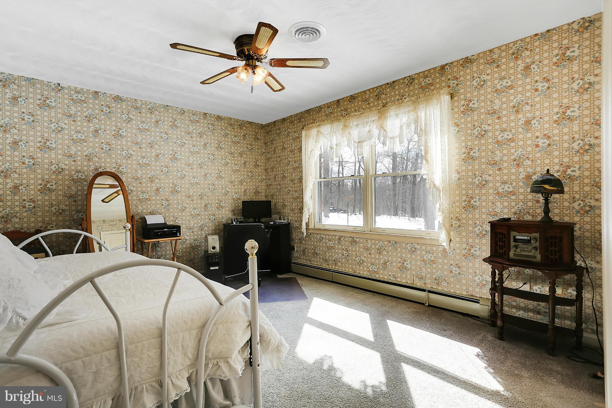 10852 Garrison Hollow Road Clear Spring, MD 21722 - Photo 14 of 30 a bedroom with a bed and a table