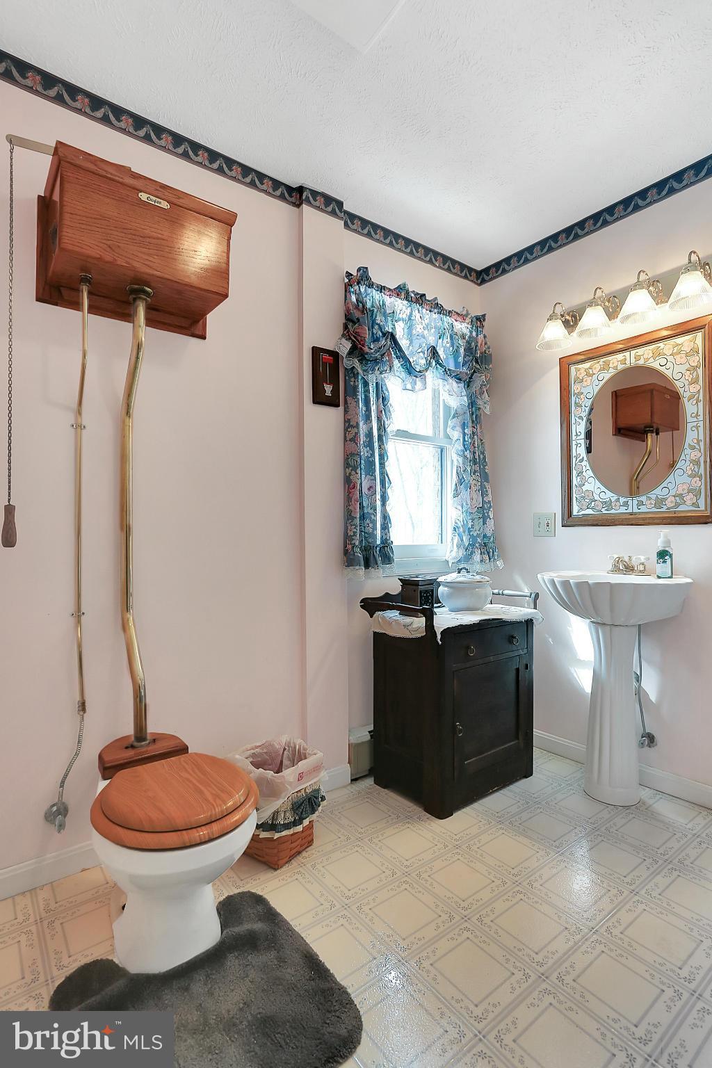 10852 Garrison Hollow Road Clear Spring, MD 21722 - Photo 18 of 30 a bathroom with a toilet a sink and a mirror