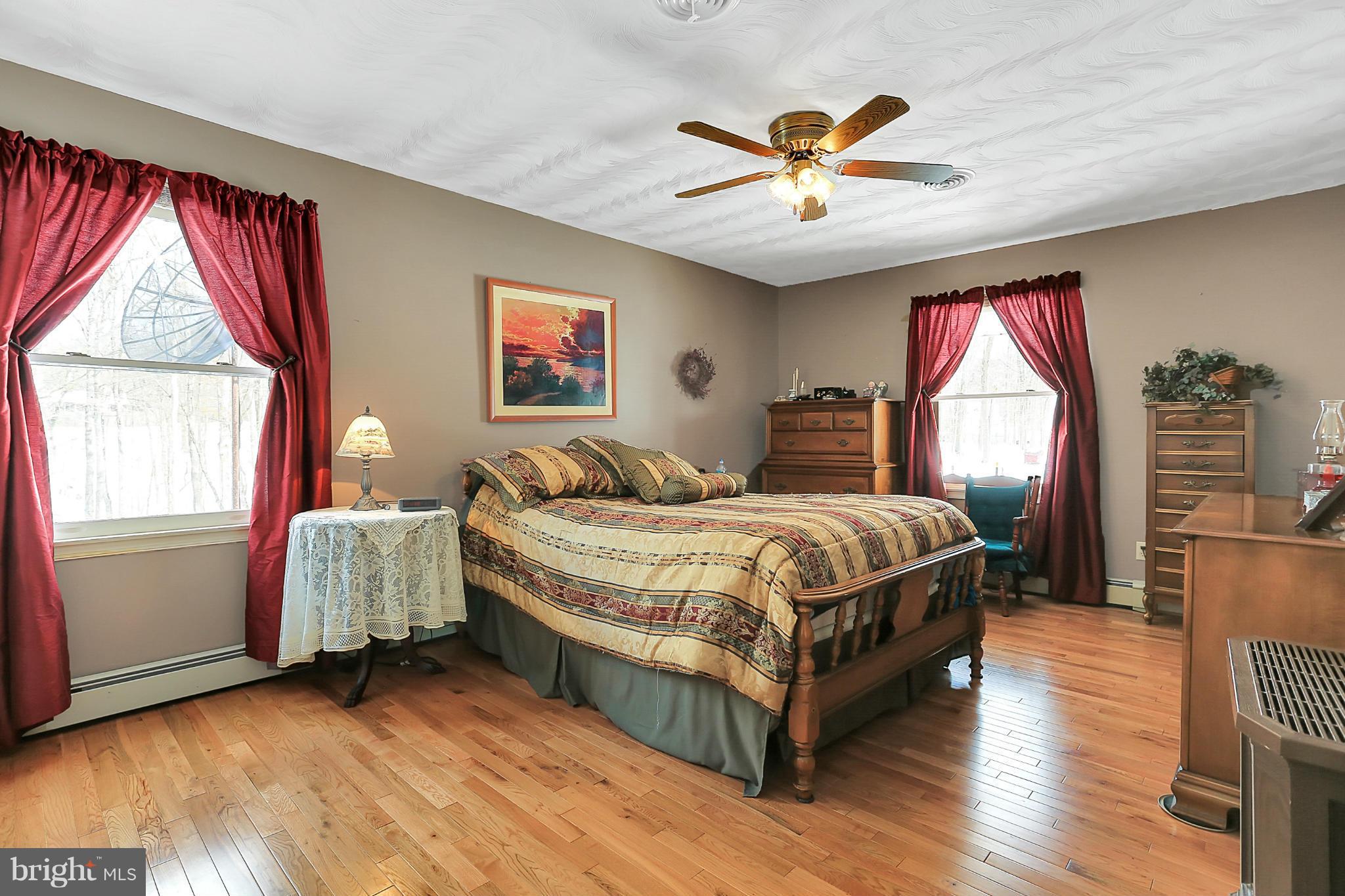 10852 Garrison Hollow Road Clear Spring, MD 21722 - Photo 21 of 30 a bedroom with a bed and a large window